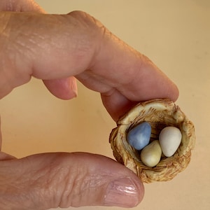 tiny porcelain bird&#39;s nest with eggs