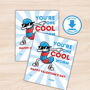 May include: Two Valentine's Day cards with a cartoon worm wearing sunglasses and dabbing. The cards read "YOU'RE ONE COOL WORM" and "HAPPY VALENTINE'S DAY". The background is light blue with white rays.