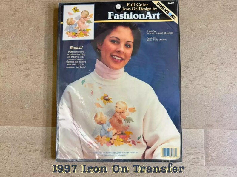 The image is a 1997 Iron On Transfer package featuring a smiling woman with a white sweater adorned with angel designs.