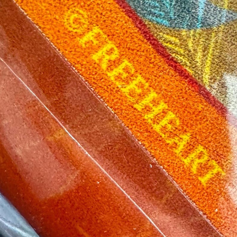 The image is a close-up of a textured surface with a vibrant orange and yellow pattern.
