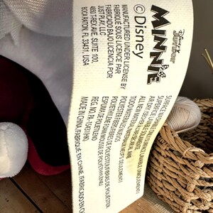 a label with text, likely from a product, placed on a surface next to a woven basket.