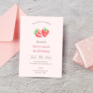 May include: A pink invitation card with a watercolor illustration of two strawberries. The text on the card reads "Please join us to celebrate Scout's berry sweet 1st birthday. March 15 1:00pm The Smith Residence 123 Sunshine Dr. Scottsdale, AZ RSVP To Sarah by March 1st (223) 436 - 7890"