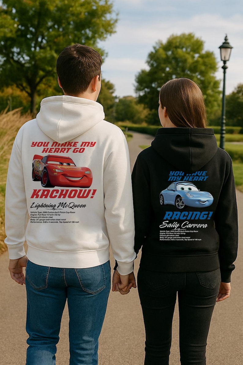 May include: Two people wearing matching hoodies, one white and one black. The white hoodie features Lightning McQueen with "YOU MAKE MY HEART GO" and "KACHOW!". The black hoodie shows Sally Carrera with "YOU HAVE MY HEART" and "RACING!"