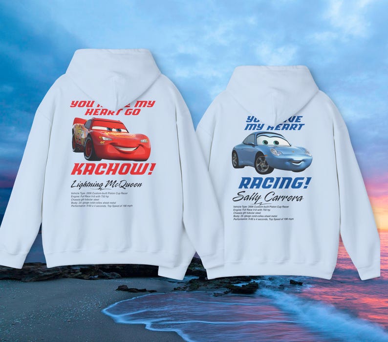 May include: Two white hooded sweatshirts with cartoon car graphics. One features Lightning McQueen with "Kachow!" and the text "You stole my heart go". The other displays Sally Carrera with "Racing!" and "You are my heart".