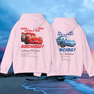 May include: Two light pink hoodies with car graphics. One features Lightning McQueen with "Kachow!" and "You stole my heart go" text. The other has Sally Carrera with "Racing!" and "You stole my heart" text.