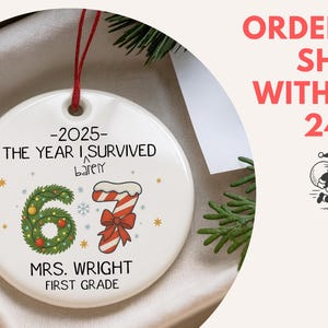 May include: A white ceramic Christmas ornament with a red string. The ornament features the text "-2025- THE YEAR I SURVIVED barely" and "MRS. WRIGHT FIRST GRADE". It has a green wreath and a candy cane design with the number "67".