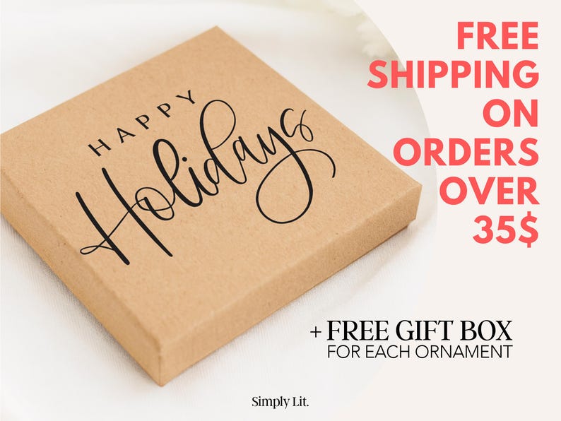 May include: A square, light brown box with the words "HAPPY Holidays" in black script. The box is on a white surface. The text "Simply Lit" is at the bottom left.