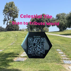 May include: A black hexagonal tile with a QR code and the text "Rosehills" and "Lucy Yiman Lu". The tile is on a grassy surface with a path leading to a cemetery in the background. The text "Celestial Tile Scan to Tribute World" is written in pink at the top of the image.