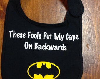 Super hero bib- Black- "These fools put my cape on backwards"