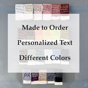 May include: A display of ceramic tiles in various colors, arranged in rows. The tiles have a textured surface and are two-toned, with a white base. The image includes the text "Made to Order," "Personalized Text," and "Different Colors."