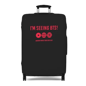 May include: Black suitcase with a pull-out handle. The cover displays the red text "I'M SEEING BTS!", a graphic, and "ARIRANG WORLD TOUR 2026-2027". Ideal for travel, this luggage is designed for ease of use.