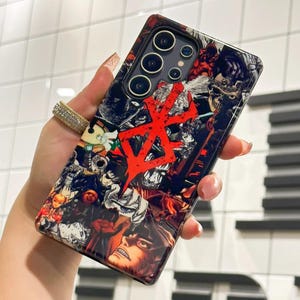May include: A black phone case with a colorful anime-style design. The case features a red kanji character and a variety of characters from different anime series. The phone case is designed for a Samsung Galaxy S22 Ultra.