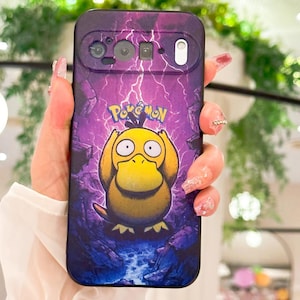 May include: A purple phone case featuring a yellow Psyduck Pok&eacute;mon character with the Pok&eacute;mon logo. The case has a lightning bolt design and a rocky landscape background.