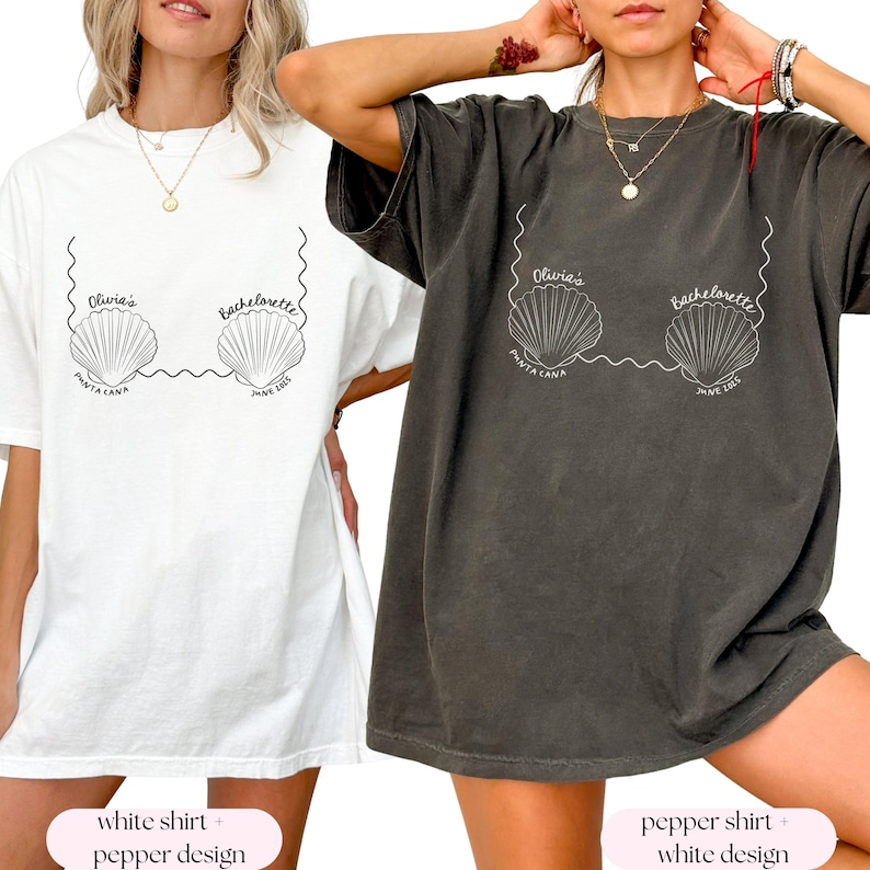 May include: Two oversized t-shirts with a white design of seashells and the text "Olivia's Bachelorette Punta Cana June 2023". One shirt is white and the other is a dark gray color.