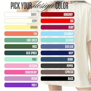 Peut inclure: Un t-shirt cr&egrave;me avec un nuancier affichant les options de couleur de conception. Le nuancier comprend des couleurs comme le blanc, l'ivoire, le rouge, le bleu et le noir. Le texte "PICK YOUR design COLOR" est en haut. Le t-shirt est port&eacute; par une personne.