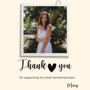May include: A woman in a white dress stands in front of a green bush. The image is in a white frame with a silver clip at the top. The text "Thank you" with a black heart in between the words is below the image. The text "for supporting my small woman-business" is below the text "Thank you". The name "Mary" is at the bottom of the image.