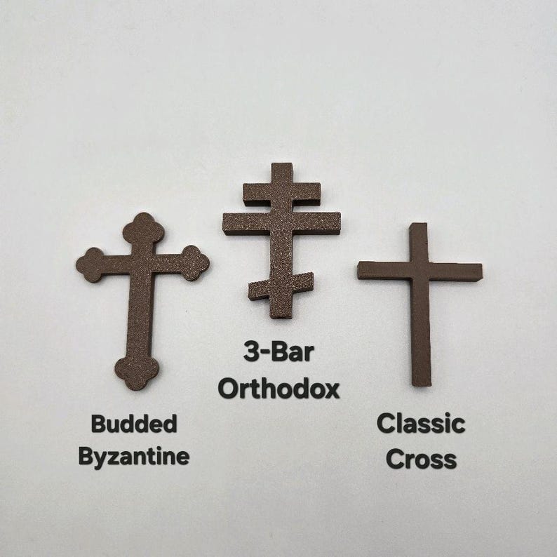 May include: Three brown crosses: a Budded Byzantine cross, a 3-Bar Orthodox cross, and a Classic Cross. The names of each cross are printed below them in black text. The crosses are displayed on a white background.