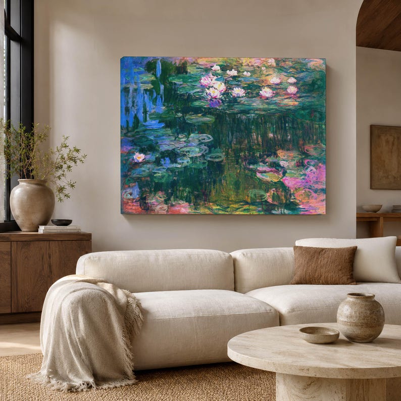 May include: A rectangular canvas wall art print featuring an impressionist style painting of a water lily pond. The artwork displays deep blue, green, and dark tones with scattered pink and white water lilies floating on the water surface.