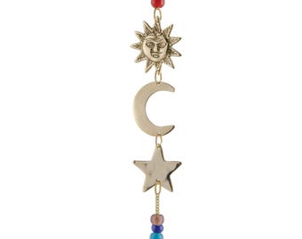 May include: A gold sun, moon and star hanging mobile with a rainbow of beads and a bell at the bottom.