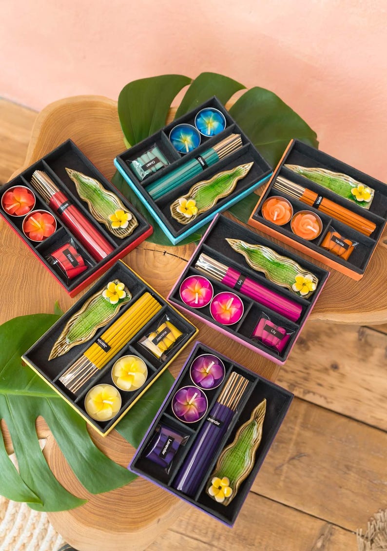 May include: Six colorful gift boxes with incense sticks, tealight candles, and a leaf-shaped incense holder. Each box has a different color and scent, including lavender, sandalwood, jasmine, and vanilla.