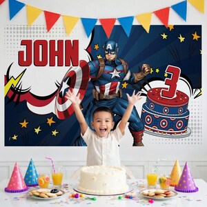 May include: A birthday party scene with a child in front of a Captain America backdrop. The backdrop features the name "JOHN" and a cake with the number "3". A white cake and party hats are on the table.