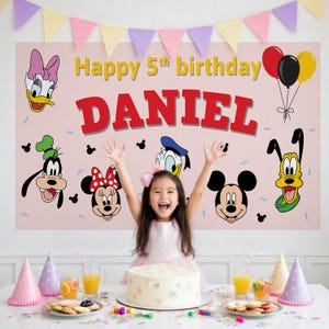 May include: A pink birthday banner with Disney characters, the text "Happy 5th birthday DANIEL", and balloons. A young girl is in front of a table with a cake, party hats, and snacks.