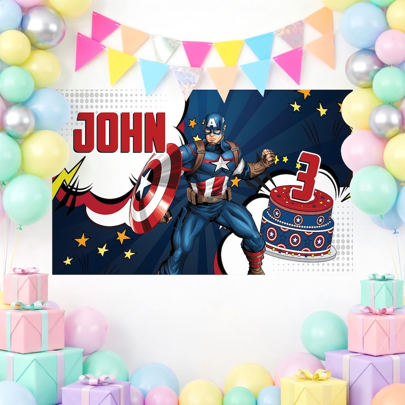 May include: A birthday party backdrop featuring Captain America with a shield, a cake with a number 3, and the name "JOHN". The backdrop is decorated with balloons and a colorful banner. The overall theme is a superhero birthday celebration.