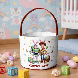 May include: A white ceramic mug with a black handle and the text "But First, Coffee" in a black, handwritten-style font. The mug is on a white surface.