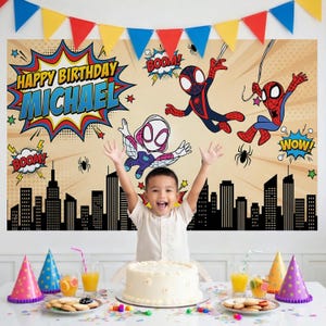 May include: A birthday party scene with a child in front of a backdrop featuring Spider-Man characters and the text "Happy Birthday Michael." A cake, party hats, and snacks are on the table. Colourful bunting hangs above.