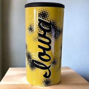 May include: Yellow stainless steel tumbler with a black lid and a black and white graphic design that says "Love" in a stylized font.