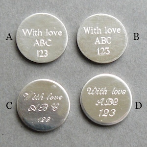 May include: Four silver round tokens with the text "With love ABC 123" engraved on them. The tokens are arranged in a grid pattern.
