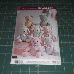 May include: A Simplicity sewing pattern for making stuffed animals. The pattern includes instructions for making a bear, a cat, a dog, and a bunny. The pattern is for sizes OS. The pattern is designed and printed in the USA.