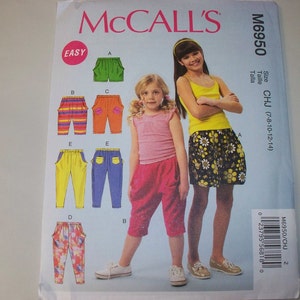 May include: McCall's sewing pattern M6950 for girls' pants and skirt. The pattern includes various styles of pants in different colors and patterns, and a skirt with a floral design. The pattern is labeled "EASY".