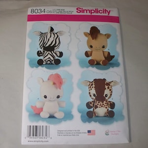 May include: A sewing pattern for making four plush stuffed animals: a zebra, a horse, a unicorn, and a giraffe. The pattern is from Simplicity and is for one size. The pattern number is 8034.