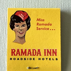 May include: A vintage matchbook with a yellow background. The matchbook features an illustration of a woman wearing a red hat with the text "Miss Ramada" and the words "Miss Ramada Service..." The text "Ramada Inn Roadside Hotels" is printed in red.