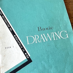 May include: A vintage art instruction book titled "Basic Drawing." The cover is a teal color with white text. The book is from Art Instruction Inc., Minneapolis 15, Minn. and is labeled "Book 1."