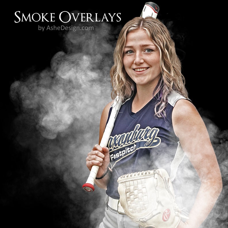 May include: A young woman in a navy blue softball jersey with the text "Lexington Fastpitch" holds a white baseball bat with a red grip. She is wearing a white baseball cap and a white glove. The image is surrounded by a white smoke effect.