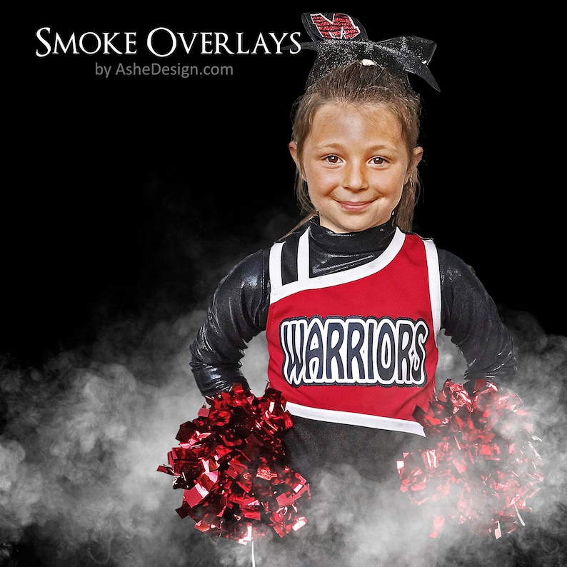 May include: A young cheerleader wearing a red and black uniform with the word "WARRIORS" on the front. She is holding two red pom-poms and is standing in front of a white smoke background.