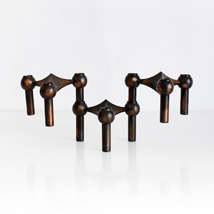 May include: A set of three ceramic mugs with a speckled, matte finish. The mugs are in shades of cream, light gray, and dark gray. Each mug has a simple, modern design and a rounded handle.