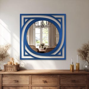 round wall mirror with modern square metal frame, minimalist black decor for living room