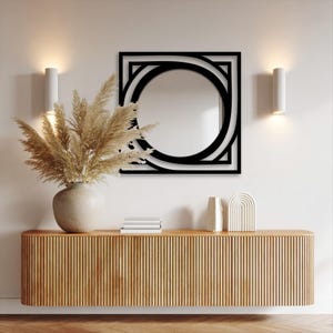 black metal frame round wall mirror featuring modern geometric square border for entryway decor