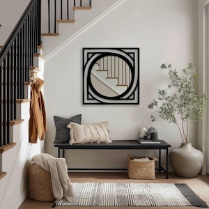 black geometric metal frame mirror surrounding round glass, sleek modern wall accent