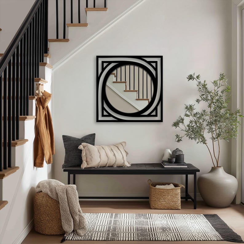 black geometric metal frame mirror surrounding round glass, sleek modern wall accent