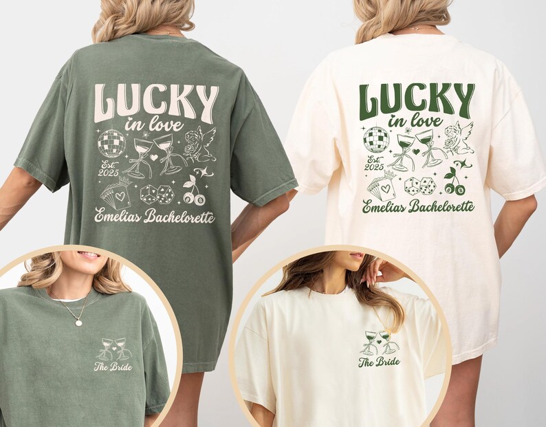 May include: Two oversized t-shirts, one olive green and one cream, feature the text "LUCKY in love" with decorative graphics. The olive shirt has the text "Emelias Bachelorette" and "Est 2025". The cream shirt has the same design. The bottom of each shirt has the text "The Bride".