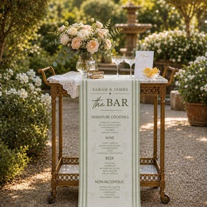 May include: A vintage-style bar cart with a marble top, holding a floral arrangement, champagne flutes, and a menu. A striped banner displays "SARAH & JAMES The BAR" with a list of cocktails, wines, beers, and non-alcoholic beverages.