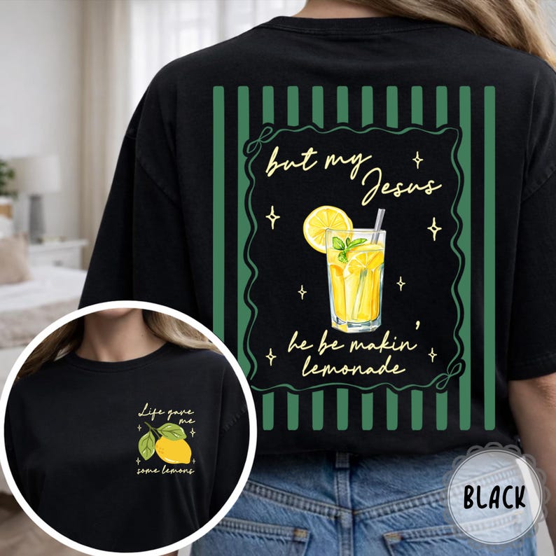 May include: Black t-shirt with a lemonade graphic. The back features a green striped border with the text "but my Jesus he be makin' lemonade." A smaller image on the front says "Life gave me some lemons."