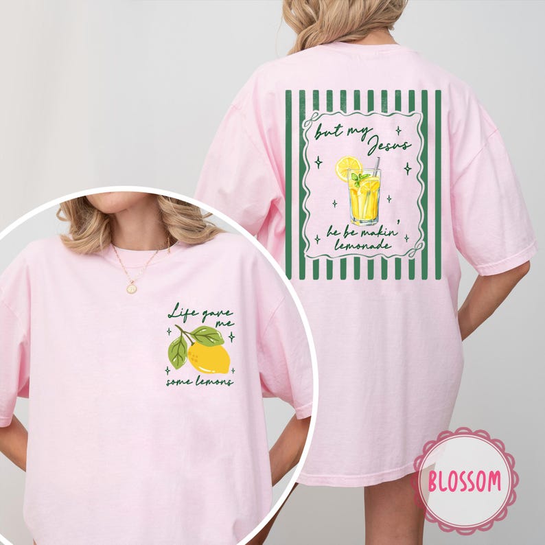 May include: Pink t-shirt with a lemon graphic and the text "Life gave me some lemons" on the front. The back features a lemonade graphic and the text "but my Jesus he be makin' lemonade".