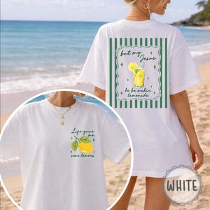 May include: White t-shirt with a lemon graphic and the text "Life gave me some lemons" on the front. The back of the shirt features a lemonade graphic and the text "but my Jesus he be makin' lemonade".
