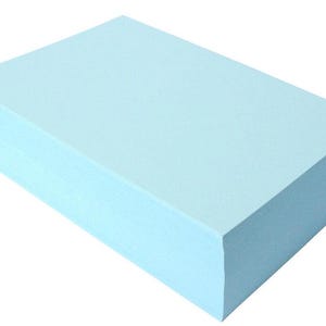 May include: A stack of light blue paper.