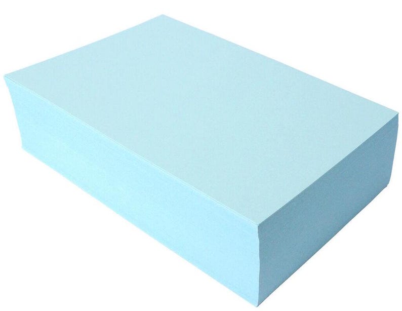 May include: A stack of light blue paper.